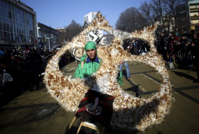 A participant dressed in traditional costume carries his mask during the International Festival of the Masquerade Games in the town of Pernik, Bulgaria January 30, 2016. (Photo by Stoyan Nenov/Reuters)
