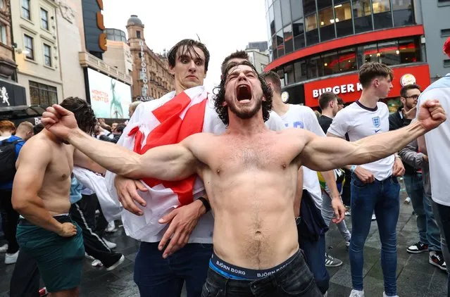 A fan looks shocked as a topless fan screams on June 29, 2021 in London, United Kingdom. England beat Germany 2-0 and are now set to play either Sweden or Ukraine in the quarter final of Euro 2020 on 3 July in Rome. (Photo by Charlotte Wilson/Offside/Offside via Getty Images)