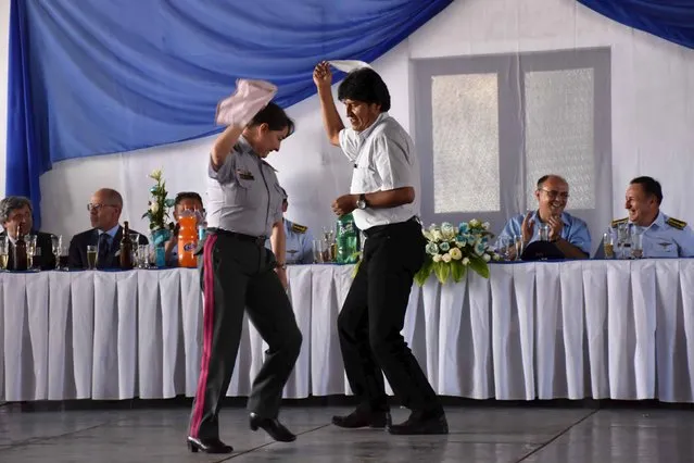 Bolivia's President Evo Morales dances with General Staff of Bolivia's Armed Forces General Gina Reque Teran during a ceremony in Cochabamba, February 5, 2016 in this handout photo provided by Bolivian Presidency. (Photo by Reuters/Bolivian Presidency)