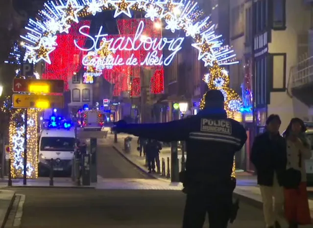 In this image made from video, emergency services arrive on the scene of a Christmas market in Strasbourg, France, Tuesday, December 11, 2018. A French regional official says that a shooting in Strasbourg has left at least one dead and several wounded in the city center near a world-famous Christmas market. The prefect of France's Bas-Rhin region says the gunman, who is still at large, has been identified. Authorities haven't given a motive for the shooting. (Photo by AP Photo/Stringer)