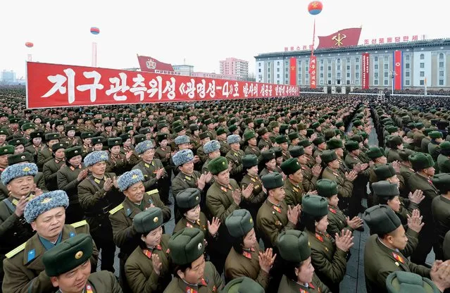 This photo dated on February 8, 2016 and released by North Korea's official Korean Central News Agency (KCNA) on February 9, 2016 shows North Korean people and soldiers celebrating a report on North Korea's rocket launch in Pyongyang. North Korea said on February 7, it had successfully put a satellite into orbit, with a rocket launch widely condemned as a ballistic missile test for a weapons delivery system to strike the US mainland. (Photo by AFP Photo/KCNA via KNS)