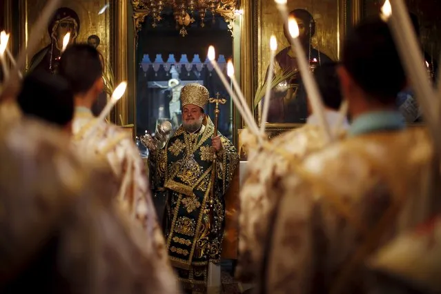 Orthodox Christians hold candles as they attend Palm Sunday mass at the Saint Porfirios church in Gaza City April 5, 2015. (Photo by Suhaib Salem/Reuters)