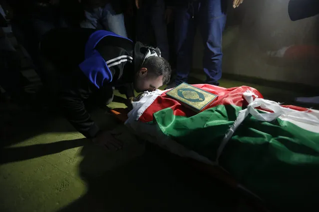 Palestinian kisses 32-year-old Mohammed al-Salhi during his funeral  in Fara Refugee Camp near the West Bank city of Nablus, Tuesday, January 10 2017. Israeli military said troops have shot dead al-Salhi when he tried to stab soldiers in the West Bank. Palestinians said al-Salhi was shot dead in his home. (Photo by Majdi Mohammed/AP Photo)