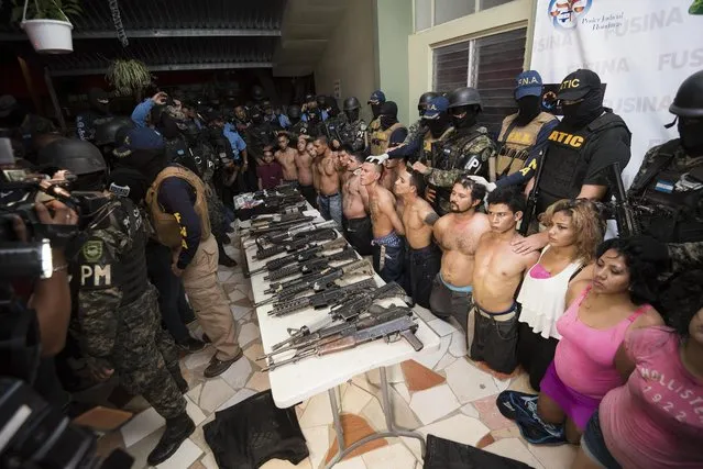 Members of the National Inter-Institutional Security Force (FUSINA) present alleged members of the gang Barrio 18, who were found to be in possession of illegal weapons in San Pedro Sula, Honduras, 18 January 2017. (Photo by Jordan Perdomo/EPA)