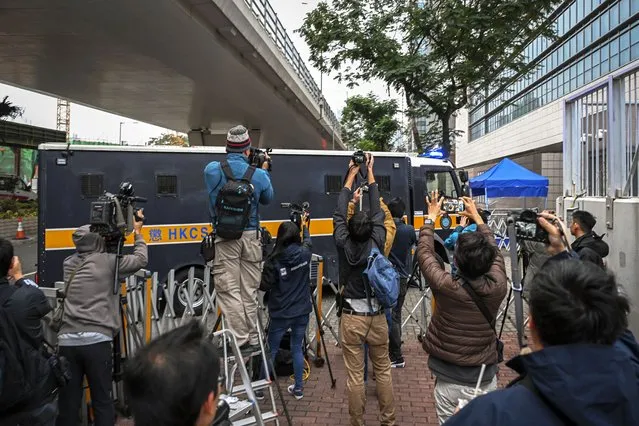 Journalists film a prison van carrying activist publisher Jimmy Lai as it enters the West Kowloon Magistrates' Courts where Lai's trial takes place in Hong Kong, Tuesday, January 2, 2024. (Photo by Billy H.C. Kwok/AP Photo)