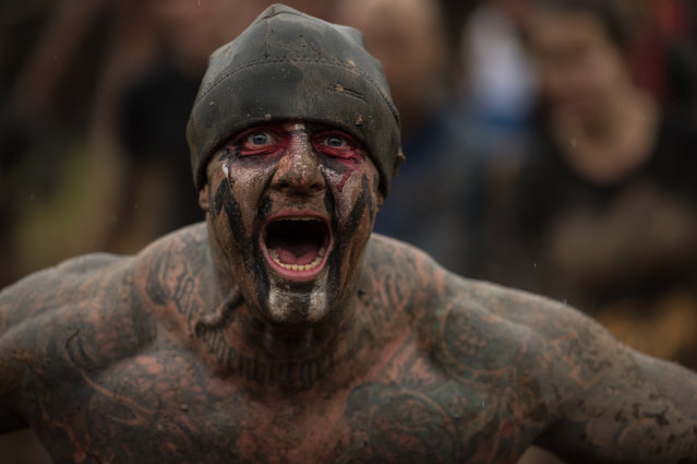 A competitor shouts as he takes part in the “Tough Guy” adventure race near Wolverhampton, central England, on January 29, 2017. The Tough Guy event, which is being held for the final time in its 30th year, challenges thousands of competitors to run a gruelling course whilst negotiating over 200 obstacles including: water, fire, and tunnels. (Photo by Oli Scarff/AFP Photo)