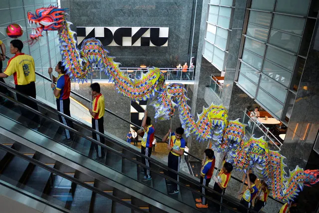 Dragon dance performers ride an escalator to perform at the trading floor of the Philippine Stock Exchange to celebrate the Chinese Lunar New Year of the Rooster in Makati city, Metro Manila, Philippines January 30, 2017. (Photo by Ezra Acayan/Reuters)