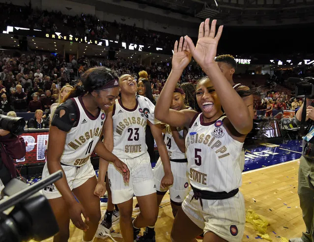 Mississippi State's Anriel Howard (5) along with her teammates celebrate after winning an NCAA college basketball championship game 101-70 against Arkansas in the Southeastern Conference women's tournament, Sunday, March 10, 2019, in Greenville, S.C. (Photo by Richard Shiro/AP Photo)