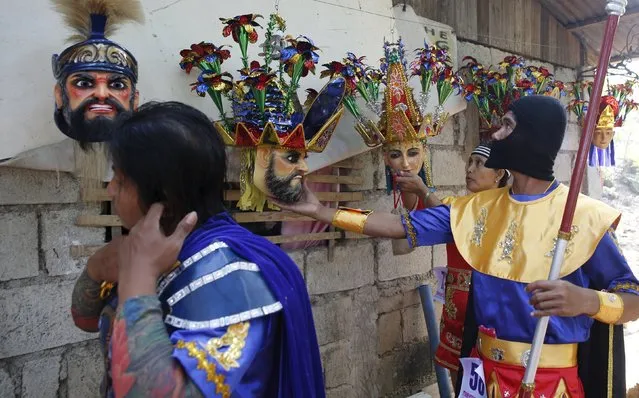 Penitents from the Mazon family get their “Morions” masks on the second day of Holy Week celebrations in Mogpog, Marinduque in central Philippines March 22, 2016. (Photo by Erik De Castro/Reuters)