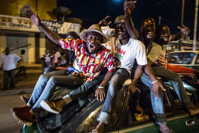 Supporters of Incumbent President Denis Sassou Nguessu celebrate in the streets of Brazzaville after informations of an early lead in the electoral results spread through the city on March 22, 2016. Congo's veteran leader Denis Sassou Nguesso has secured 67 percent of votes in his bid to extend his 32-year-old rule, partial results showed Tuesday, after a tense weekend poll. The results covered 69 percent of the total electorate, the chief of the electoral commission Henri Bouka said, adding that they did not cover Pointe-Noire, the economic capital and opposition stronghold. (Photo by Marco Longari/AFP Photo)