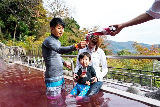 A sommelier serves the glass with 2021 Beaujolais Nouveau wine of a man bathing in a red colored hot water bath, on the day of the Beaujolais Nouveau official release, at Hakone Kowakien Yunessun hot spring resort in Hakone, Japan, 18 November 2021. Japan is a major market for the Beaujolais Nouveau. However, the country's total Beaujolais Nouveau imports are expected to fall by 20 per cent from 2019 to around 3,6 million bottles, amid the ongoing coronavirus pandemic. (Photo by Franck Robichon/EPA/EFE)