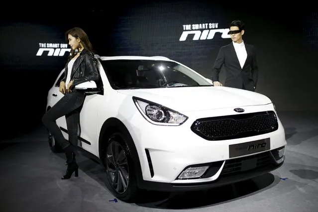 Models pose for photographs with Kia Motors' hybrid subcompact SUV Niro during its unveiling ceremony in Seoul, South Korea, March 29, 2016. (Photo by Kim Hong-Ji/Reuters)