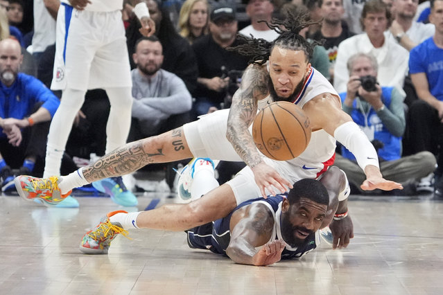 Los Angeles Clippers guard Amir Coffey, top, and Dallas Mavericks guard Kyrie Irving dive for a loose ball during the second half in Game 5 of an NBA basketball first-round playoff series Wednesday, May 1, 2024, in Los Angeles. (Photo by Mark J. Terrill/AP Photo)