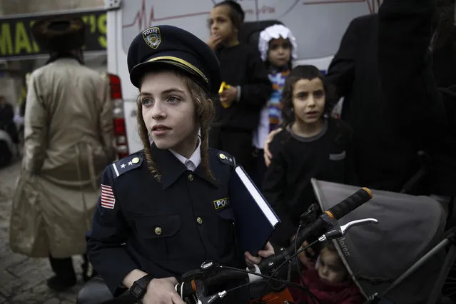 Ultra-Orthodox Jews wearing costumes celebrate the Jewish holiday of Purim in the ultra-Orthodox neighborhood of Mea Shearim in Jerusalem, Israel, March 13, 2017. The Jewish holiday of Purim celebrates the Jews' salvation from genocide in ancient Persia, as recounted in the Book of Esther. (Photo by Corinna Kern/NurPhoto via Getty Images)