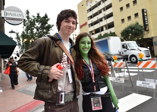 Cosplayers make their way to the Convention Center during Comic Con in San Diego, California on July 18, 2019. (Photo by Chris Delmas/AFP Photo)