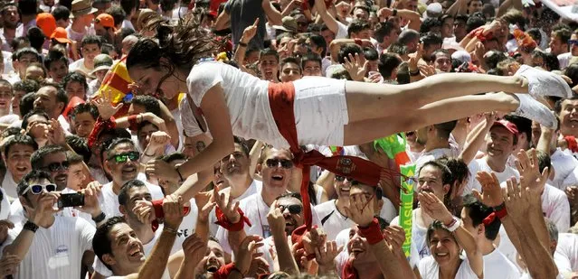 A reveller is tossed in the air at the start of the San Fermin festival in Pamplona, Spain, July 6, 2015. The festival, best known for its daily running of the bulls, kicked off today with the traditional “Chupinazo” rocket launch and will run until July 14. (Photo by Eloy Alonso/Reuters)
