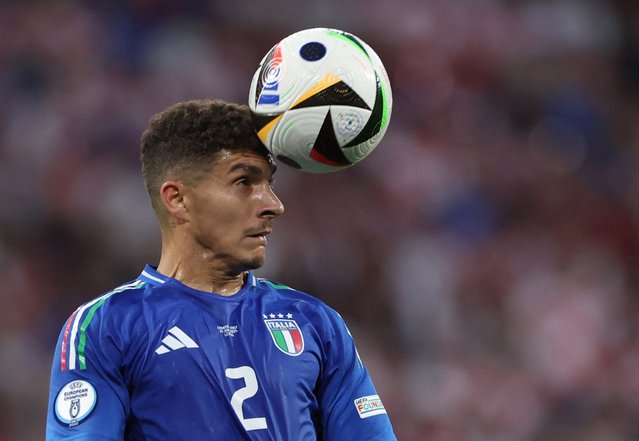 Italy's defender #02 Giovanni Di Lorenzo heads the ball during the UEFA Euro 2024 Group B football match between the Croatia and Italy at the Leipzig Stadium in Leipzig on June 24, 2024. (Photo by Ronny Hartmann/AFP Photo)