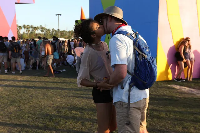 People kiss on the opening day of the Coachella Valley Music and Arts Festival on April 15, 2017 in Indio, California. (Photo by Carlo Allegri/Reuters)