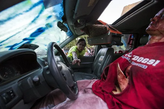 A person dressed like a zombie takes part in The Walking Dead Escape experience at Petco Park during the 2015 Comic-Con International Convention in San Diego, California July 10, 2015. (Photo by Mario Anzuoni/Reuters)