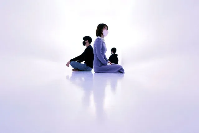 Visitors wearing protective masks, amid the coronavirus disease (COVID-19) outbreak, meditate in a bright white room at a meditation studio “Medicha”, in Tokyo, Japan, February 9, 2022. (Photo by Kim Kyung-Hoon/Reuters)