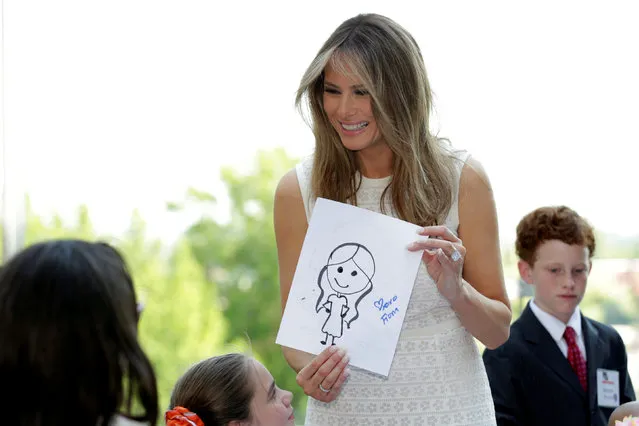 U.S. first lady Melania Trump holds a gift of a picture made by children at the opening of Bunny Mellon Healing Garden at Children's National Medical Center in Washington, U.S, April 28, 2017. (Photo by Yuri Gripas/Reuters)