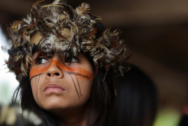 An Indigenous girl from Guarani Mbya ethnic group looks on during celebrations of Indigenous People Day in Mata Verde Bonita village in Marica near Rio de Janeiro, Brazil on April 19, 2023. (Photo by Ricardo Moraes/Reuters)