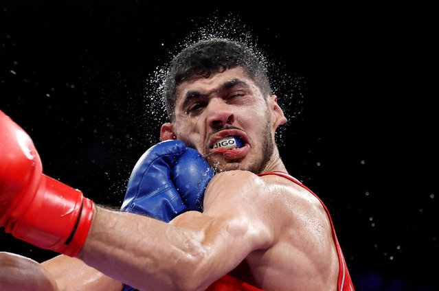 Cuba's Erislandy Alvarez (in blue) punches Algeria's Jugurtha Ait Bekka in the men's 63.5kg preliminaries round of 16 boxing match during the Paris 2024 Olympic Games at the North Paris Arena, in Villepinte on July 29, 2024. (Photo by Peter Cziborra/Reuters)