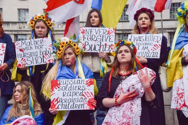 Demonstrators staged a massive “die-in” and held “babies” and signs covered in fake blood in protest against the massacre in the town of Bucha and atrocities reportedly committed by Russian forces in Ukraine in London, United Kingdom on April 9, 2022. (Photo by Vuk Valcic/ZUMA Press Wire/Rex Features/Shutterstock)