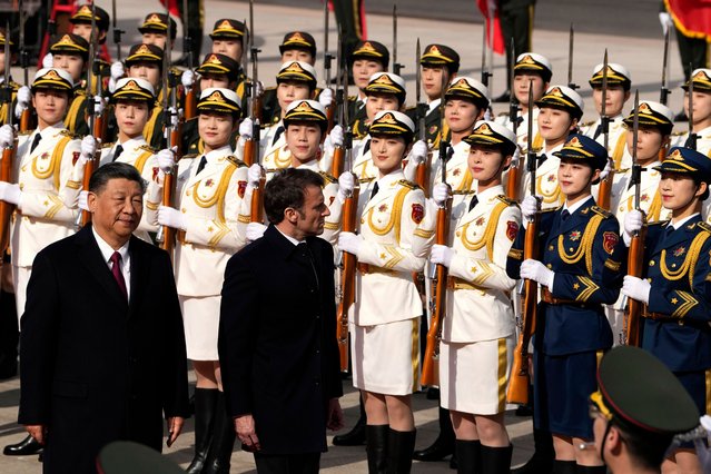 French President Emmanuel Macron (R) inspects an honor guard with Chinese President Xi Jinping (L) outside the Great Hall of the People in Beijing, China on April 6, 2023. (Photo by Ng Han Guan/EPA/EFE)