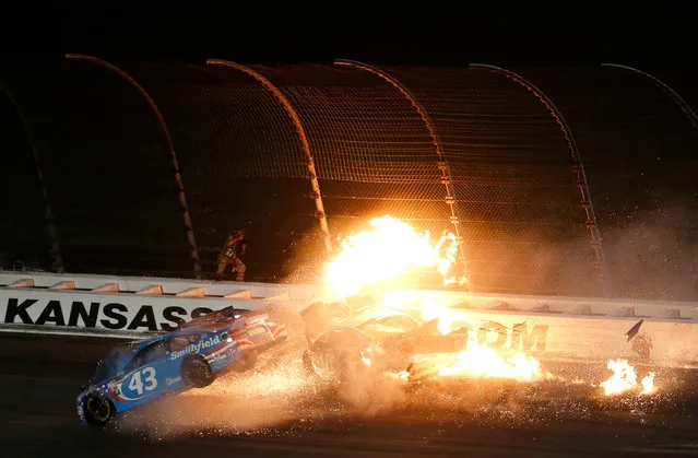 Joey Logano, driver of the #22 AAA Insurance Ford, Danica Patrick, driver of the #10 Wonder Woman/One Cure Ford, and Aric Almirola, driver of the #43 Smithfield Ford, crash during the Monster Energy NASCAR Cup Series Go Bowling 400 at Kansas Speedway on May 13, 2017 in Kansas City, Kansas. (Photo by Sean Gardner/Getty Images)