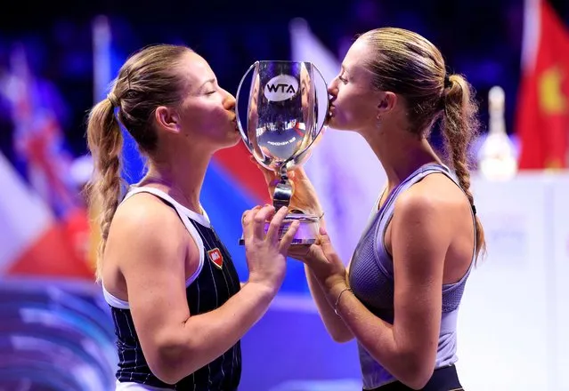 Timea Babos (L) of Hungary/Kristina Mladenovic of France kiss the trophy after the doubles final against Hsieh Su-wei of Chinese Taipei/Barbora Strycova of the Czech Republic at the WTA Finals Tennis Tournament in Shenzhen, south China's Guangdong Province, November 3, 2019. (Photo by Aly Song/Reuters)