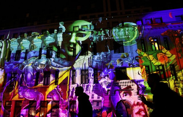 Bulgarian Development Bank building is illuminated by the light installation called “Unlimited Universe”, as part of the “Lunar” Festival of Lights in Sofia, Bulgaria on May 11, 2023. (Photo by Spasiyana Sergieva/Reuters)