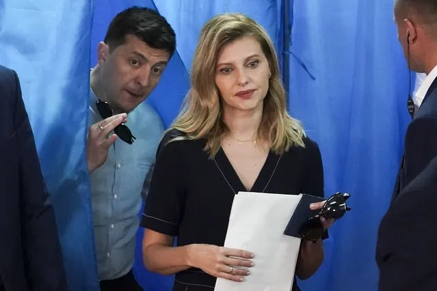 Ukrainian President Volodymyr Zelenskyy, left, and his wife Olena Zelenska leave a booth at a polling station during a parliamentary election in Kiev, Ukraine, Sunday, July 21, 2019. Ukraine's first lady, Olena Zelenska, says that the war has not changed her husband, but only revealed his qualities, including a determination to prevail, to the world. Zelenska, speaking in an interview with the Polish newspaper Rzeczpospolita published Friday, April 29, 2022, also says she has not seen her husband since Russia invaded Ukraine on Feb. 24. (Photo by Evgeniy Maloletka/AP Photo/File)