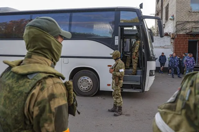 Self-proclaimed Donetsk People's Republic (DPR) militia and Russian soldier (rear R) guard buses with Ukrainian servicemen that are being evacuated from the besieged Azovstal steel plant in Mariupol, Ukraine, 17 May 2022. A total of 265 Ukrainian militants, including 51 seriously wounded, have laid down arms and surrendered to Russian forces, the Russian Ministry of Defence said on 17 May 2022. Those in need of medical assistance were sent for treatment to a hospital in Novoazovsk, the ministry states further. Russian President Putin on 21 April 2022 ordered his Defence Minister to not storm but to blockade the plant where a number of Ukrainian fighters were holding out. On 24 February, Russian troops invaded Ukrainian territory starting a conflict that has provoked destruction and a humanitarian crisis. According to the UNHCR, more than six million refugees have fled Ukraine, and a further 7.7 million people have been displaced internally within Ukraine since. (Photo by Alessandro Guerra/EPA/EFE)