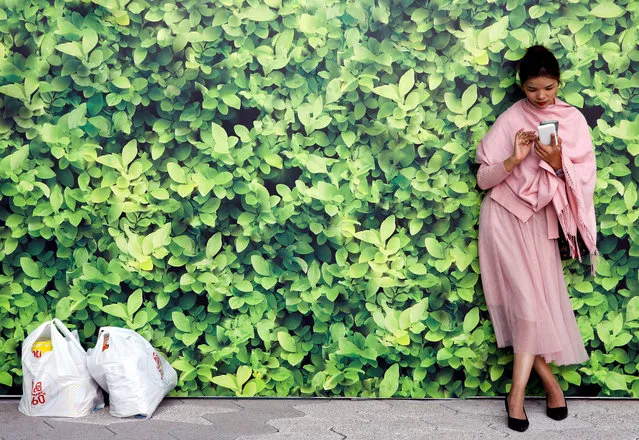 A woman uses her mobile at Tsim Sha Tsui waterfront in Hong Kong, China on December 27, 2019. (Photo by Navesh Chitrakar/Reuters)