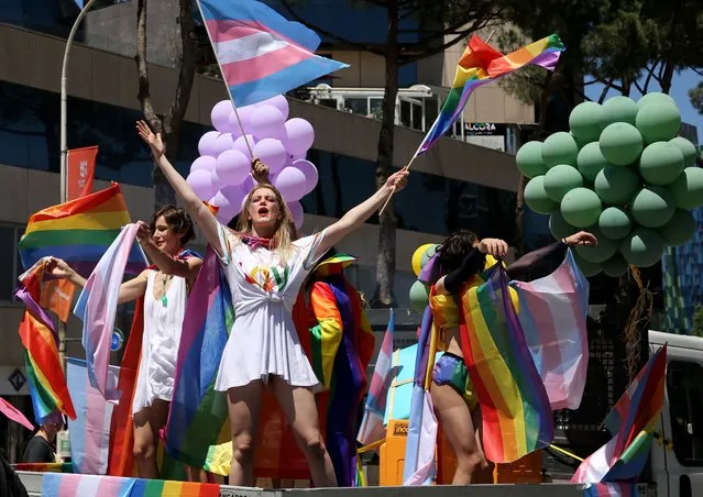 Albanian LGBT activists wave flags as they attend Tirana Gay Pride to mark the International Day Against Homophobia, Transphobia and Biphobia in Tirana on May 21, 2022. Only in recent years has the LGBT community in Albania emerged from marginalized and underground activities to hold public events and parades, although not entirely without causing controversy and prejudice in this small Balkan nation which until the collapse of the communist regime in 1990 penalized homosexuality. (Photo by Gent Shkullaku/AFP Photo)