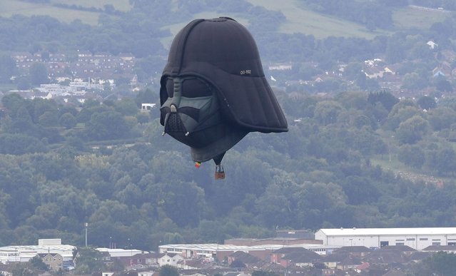Darth Vader balloon above Clifton Suspension Bridge during the hot air balloons mass ascent at sunrise on the first day of the Bristol International Balloon Fiesta on August 8, 2019 in Bristol, England. The Bristol International Balloon Fiesta is Europe's largest annual meeting of hot air balloons, attracting over 130 hot air balloons from across the globe. (Photo by Finnbarr Webster/Getty Images)
