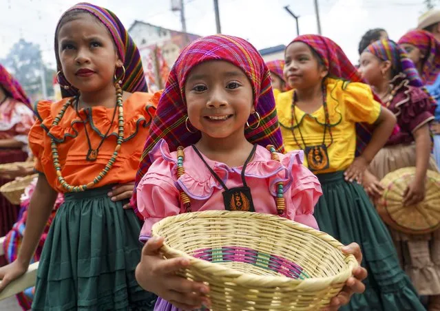 Children take part in Flower & Palm Festival in Panchimalco, El Salvador on May 8, 2022. The palms procession takes place every May in the indigenous town of Panchimalco. (Photo by Alex Pena/Anadolu Agency via Getty Images)