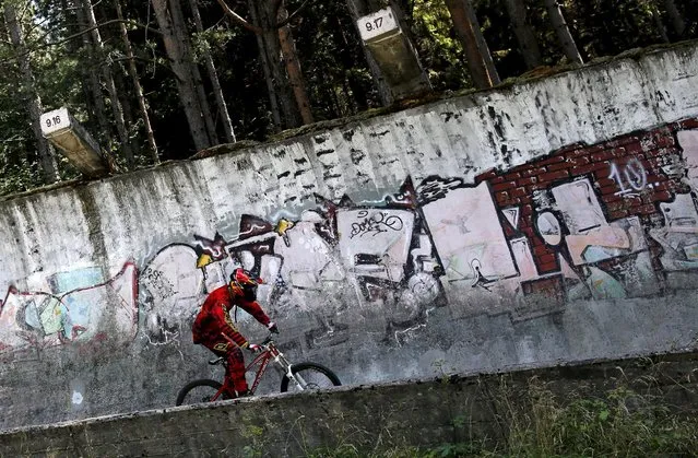 Downhill biker Kemal Mulic trains on the disused bobsled track from the 1984 Sarajevo Winter Olympics on Trebevic mountain near Sarajevo, Bosnia and Herzegovina, August 8, 2015. (Photo by Dado Ruvic/Reuters)