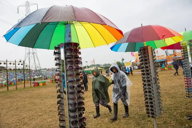Sunglasses on sale in the rain during the Glastonbury Festival, at Worthy Farm in Somerset, on June 27, 2014. (Photo by Matt Crossick/PA Wire)