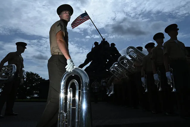 Members of the United States Marine Drum and Bugle Corps rehearse for the upcoming Sunset Parade series at the United States Marine Corps War Memorial on Tuesday June 07, 2022 in Arlington, VA. Next Tuesday is the first parade of the season at the memorial. (Photo by Matt McClain/The Washington Post)
