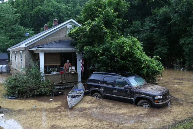 Jeff Morris watches flood waters from his porch on Midland Trail Road in Callaghan, Va., Friday, June 24, 2016. (Photo by Stephanie Klein-Davis/The Roanoke Times via AP Photo)
