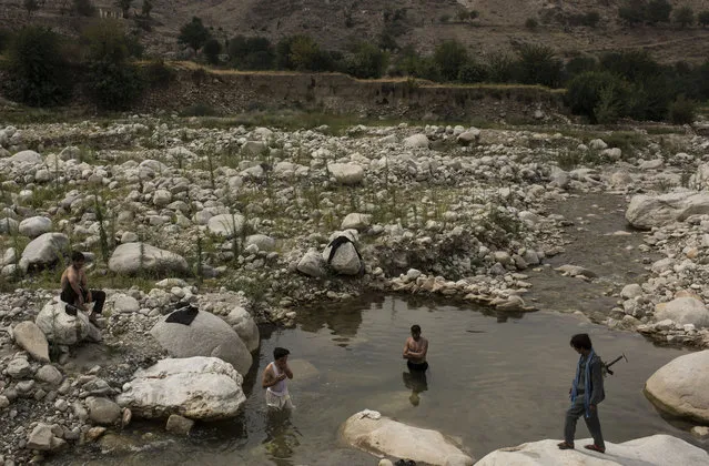 Men bathe in a river in the Momand Valley on July 16, 2017 in Achin District, Afghanistan. The area is where the United Staes dropped the GBU-43/B Massive Ordnance Air Blast, nicknamed the “Mother of All Bombs”. Operations are currently underway to remove ISIS fighters from Nangarhar Province in Eastern Afghanistan. (Photo by Andrew Renneisen/Getty Images)