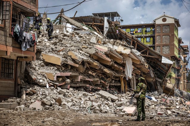 Kenya Police officer and Nairobi County emergency responders inspect the rubble of a collapsed residential building at Kahawa West residential area in Nairobi on October 20, 2024. Response teams were responding to a building collapse in Nairobi, where people are feared trapped despite a vacation notice. (Photo by Luis Tato/AFP Photo)