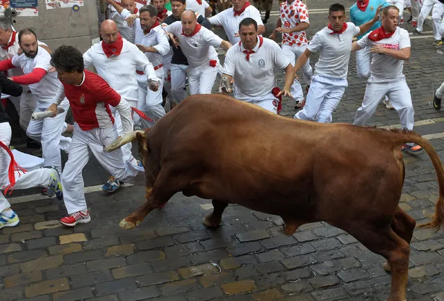 A Cebada Gago fighting bull charges runners at the Estafeta corner during the second running of the bulls at the San Fermin festival in Pamplona, northern Spain July 8, 2016. (Photo by Eloy Alonso/Reuters)