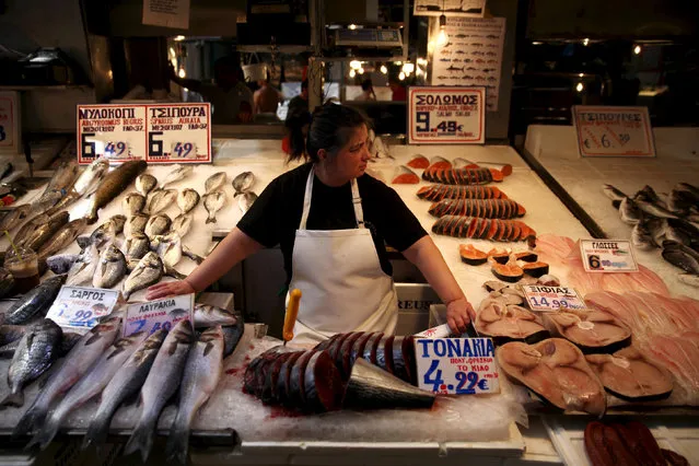A fishmonger waits for customers in a local market in central Athens, Greece, July 20, 2015. (Photo by Yiannis Kourtoglou/Reuters)