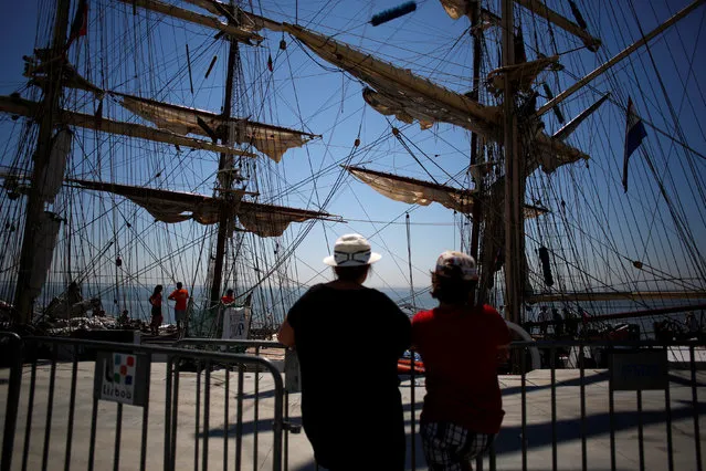 People look on during the Tall Ships Races 2016 parade, in Lisbon, Portugal July 25, 2016. (Photo by Pedro Nunes/Reuters)