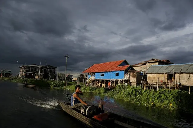 A man travels in a boat on Inle lake, in Myanmar's Shan State September 4, 2015. (Photo by Soe Zeya Tun/Reuters)