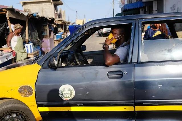 A taxi driver wears face mask at the Nima market, as Ghana lifts partial lockdown amid the spread of the coronavirus disease (COVID-19), in Accra, Ghana on April 20, 2020. (Photo by Francis Kokoroko/Reuters)