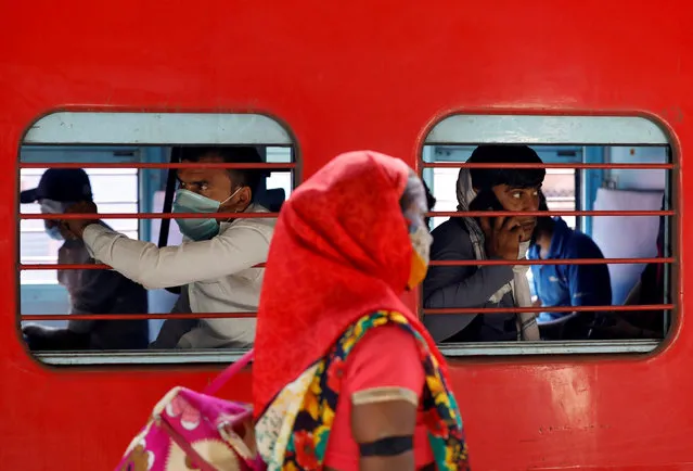 Migrant workers, who were stranded in the western state of Gujarat due to a lockdown imposed by the government to prevent the spread of coronavirus disease (COVID-19), sit inside a train as they leave for their home state of Uttar Pradesh, in Ahmedabad, India, May 2, 2020. (Photo by Amit Dave/Reuters)